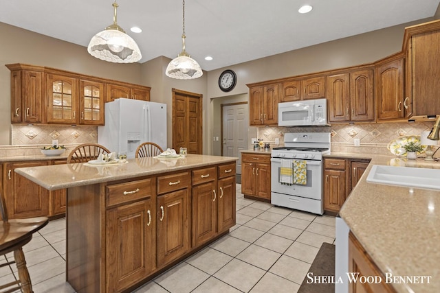 903 10 Mile Rd NW, Sparta, MI 49345 - kitchen featuring white appliances, tasteful backsplash, brown cabinetry, light tile patterned floors, and recessed lighting
