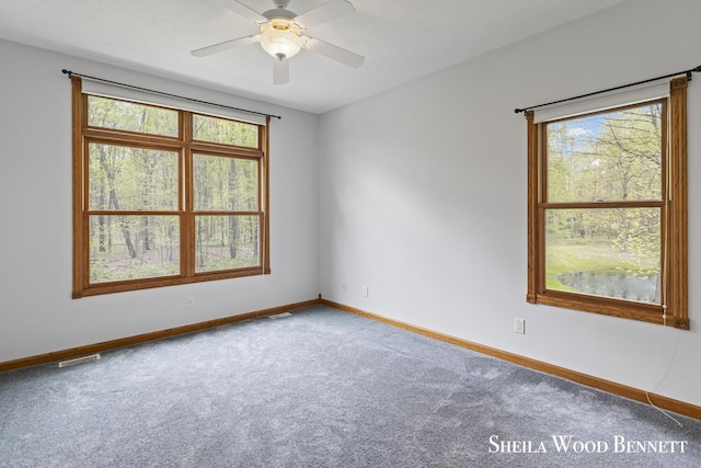903 10 Mile Rd NW, Sparta, MI 49345 - empty room with carpet flooring, plenty of natural light, baseboards, and ceiling fan