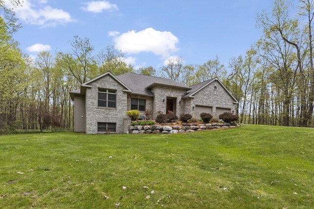 903 10 Mile Rd NW, Sparta, MI 49345 - view of front of property featuring a front lawn, an attached garage, and brick siding