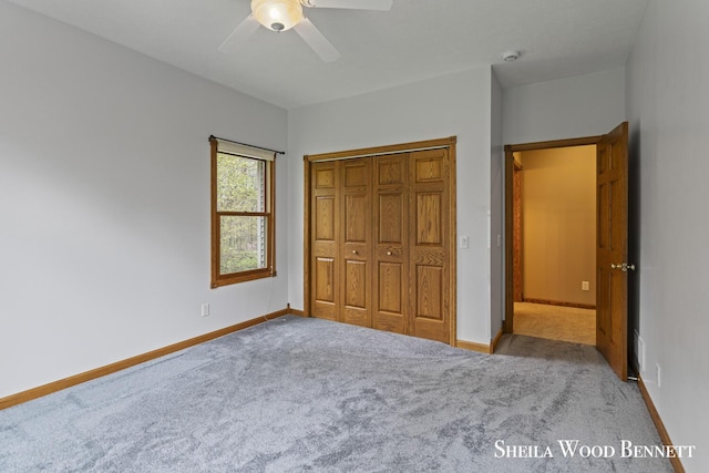 903 10 Mile Rd NW, Sparta, MI 49345 - unfurnished bedroom with carpet, baseboards, a closet, and ceiling fan