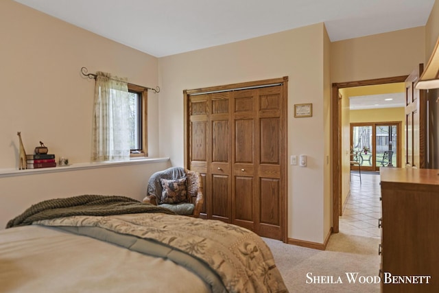 903 10 Mile Rd NW, Sparta, MI 49345 - bedroom with light colored carpet, baseboards, and a closet