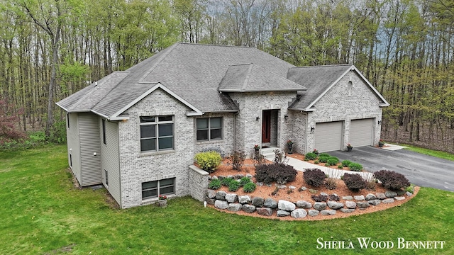 903 10 Mile Rd NW, Sparta, MI 49345 - view of front of home featuring a front yard, driveway, an attached garage, roof with shingles, and brick siding