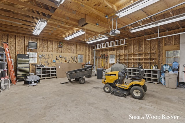 903 10 Mile Rd NW, Sparta, MI 49345 - garage with a workshop area and a garage door opener