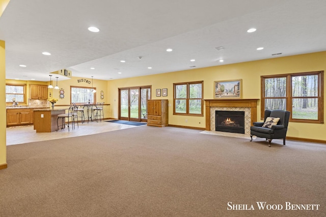 903 10 Mile Rd NW, Sparta, MI 49345 - living room with light carpet, baseboards, recessed lighting, a fireplace with flush hearth, and healthy amount of natural light
