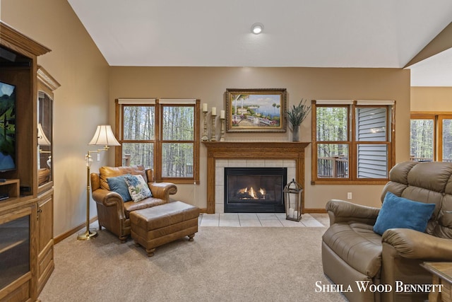903 10 Mile Rd NW, Sparta, MI 49345 - carpeted living area featuring a tile fireplace, vaulted ceiling, baseboards, and tile patterned flooring