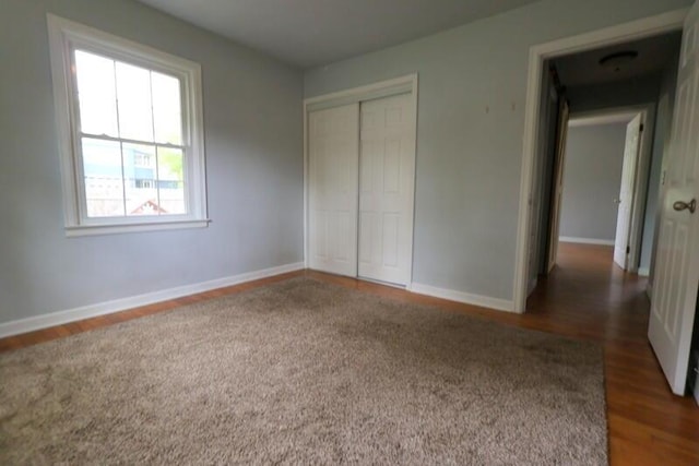 126 Barry St, Union City, MI 49094 - unfurnished bedroom featuring wood finished floors, a closet, and baseboards