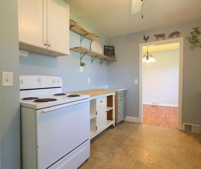 126 Barry St, Union City, MI 49094 - kitchen with open shelves, electric range, white cabinets, light countertops, and a chandelier