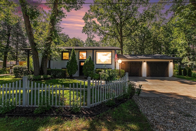 819 W Michigan St, New Buffalo, MI 49117 - view of front of home featuring driveway, a garage, and a fenced front yard