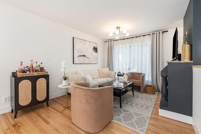 819 W Michigan St, New Buffalo, MI 49117 - living area with light wood finished floors, a chandelier, and baseboards