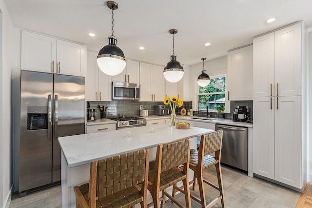 819 W Michigan St, New Buffalo, MI 49117 - kitchen featuring appliances with stainless steel finishes, a sink, tasteful backsplash, white cabinetry, and recessed lighting