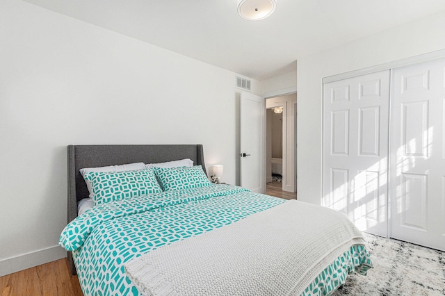819 W Michigan St, New Buffalo, MI 49117 - bedroom featuring a closet, baseboards, and wood finished floors