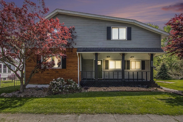 111 W 4th St, Buchanan, MI 49107 - view of front facade featuring covered porch and a lawn