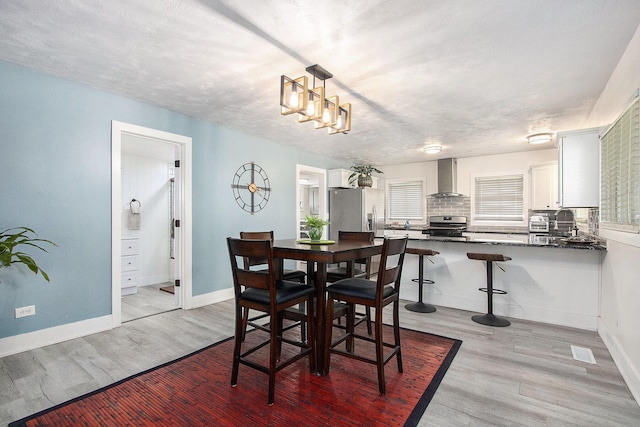 111 W 4th St, Buchanan, MI 49107 - dining area featuring light wood-style floors and baseboards