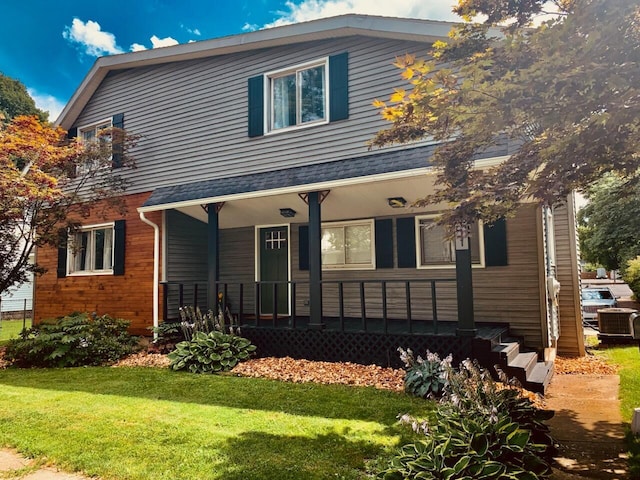 111 W 4th St, Buchanan, MI 49107 - view of front of house featuring covered porch, a front lawn, and cooling unit