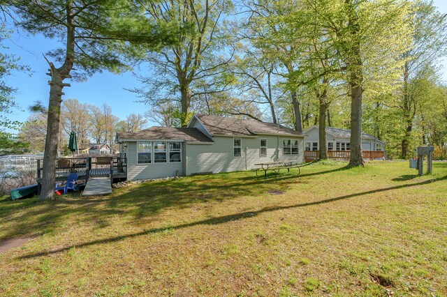 10982 Beech Is, Plainwell, MI 49080 - rear view of house featuring a deck and a lawn