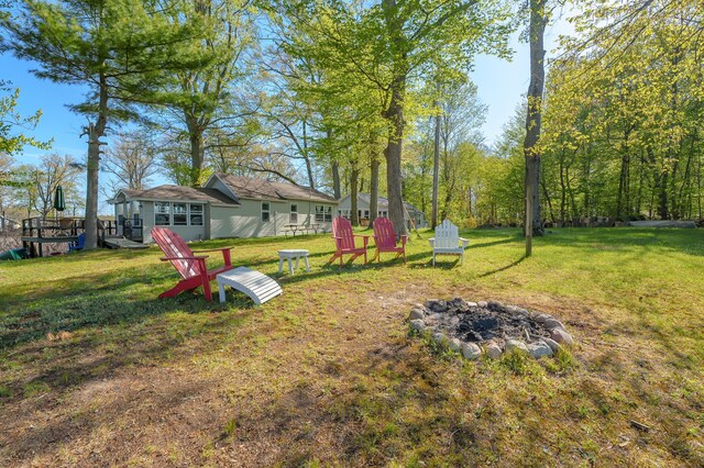 10982 Beech Is, Plainwell, MI 49080 - view of grassy yard featuring an outdoor fire pit and a wooden deck