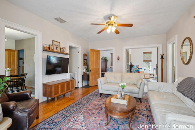 living area featuring ceiling fan and wood finished floors