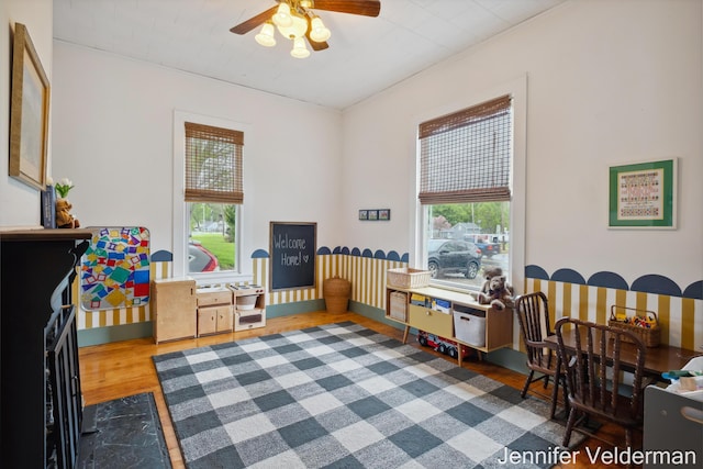 playroom with wood finished floors and a ceiling fan