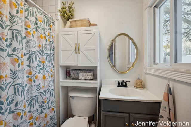 bathroom with vanity, toilet, and a shower with curtain