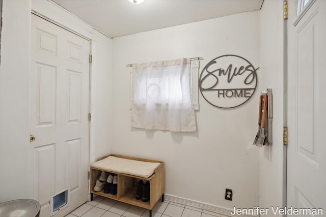 mudroom featuring light tile patterned floors and baseboards