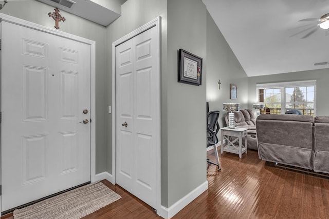 foyer with dark wood-style floors, baseboards, a ceiling fan, and vaulted ceiling