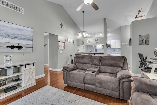 living room featuring ceiling fan, wood finished floors, baseboards, and high vaulted ceiling