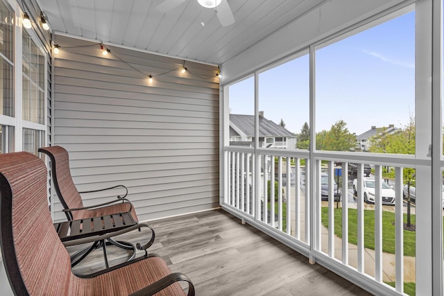 sunroom featuring ceiling fan