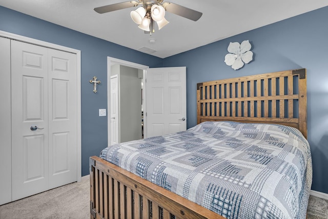 bedroom with carpet flooring, a closet, baseboards, and a ceiling fan