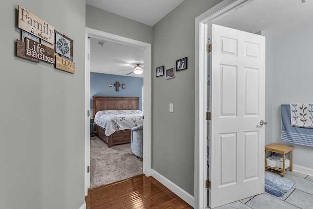 hallway featuring baseboards