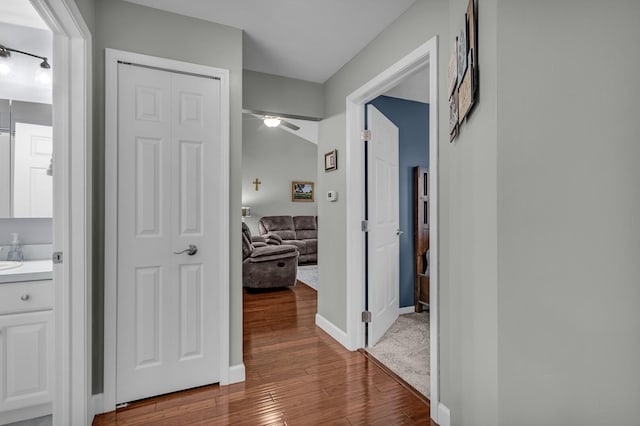 hallway with wood finished floors and baseboards