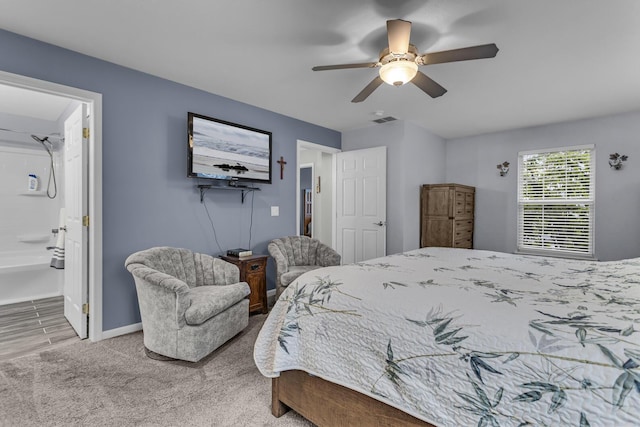 carpeted bedroom featuring baseboards, ceiling fan, and ensuite bath