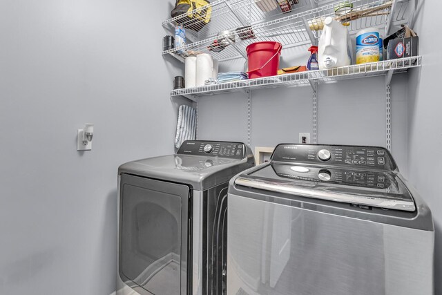 clothes washing area with independent washer and dryer