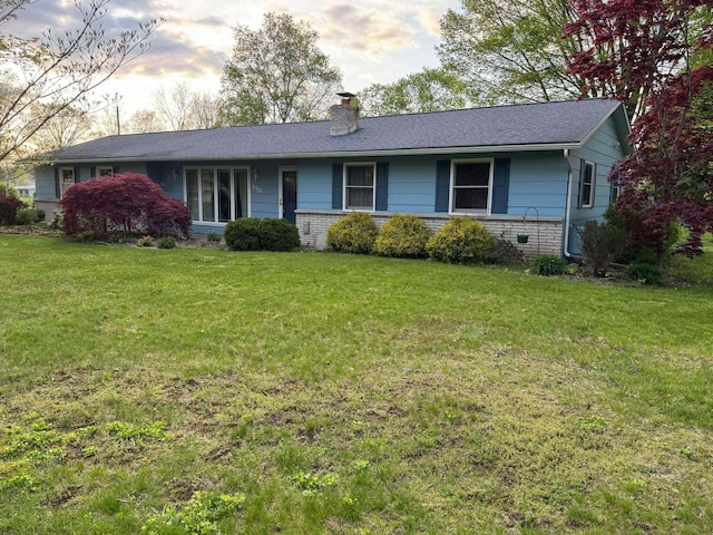 single story home featuring a chimney, a front lawn, and a shingled roof