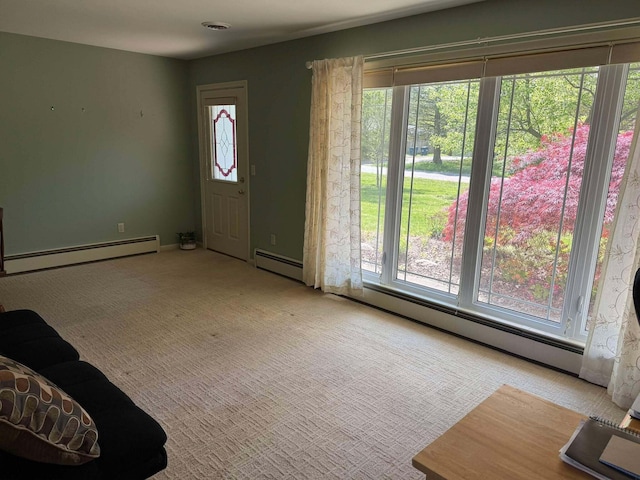 foyer entrance with a baseboard heating unit and plenty of natural light