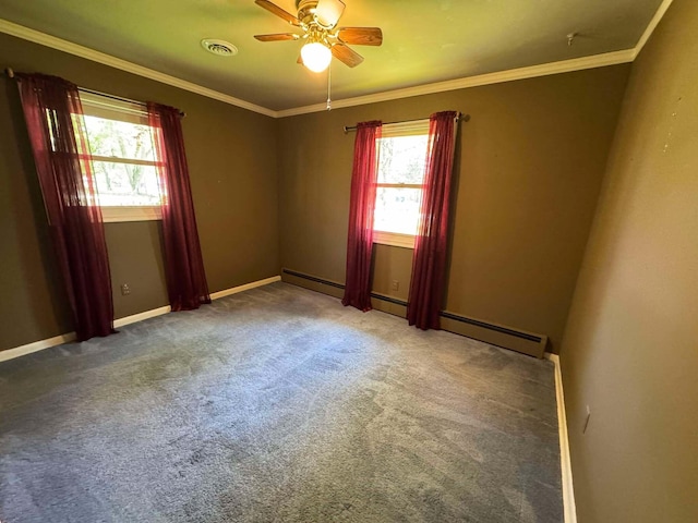 carpeted empty room with healthy amount of natural light, a ceiling fan, ornamental molding, and baseboards