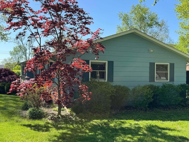 view of property exterior featuring a lawn