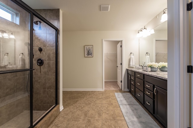 2767 St Regis Way, Ann Arbor, MI 48105 - bathroom with double vanity, a stall shower, a walk in closet, tile patterned floors, and baseboards