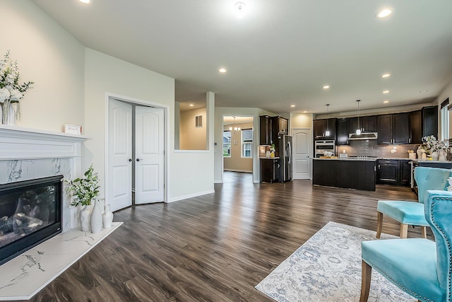 2767 St Regis Way, Ann Arbor, MI 48105 - living room with dark wood-style floors, a high end fireplace, recessed lighting, baseboards, and a chandelier