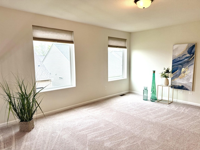 2767 St Regis Way, Ann Arbor, MI 48105 - spare room featuring carpet flooring, healthy amount of natural light, and baseboards