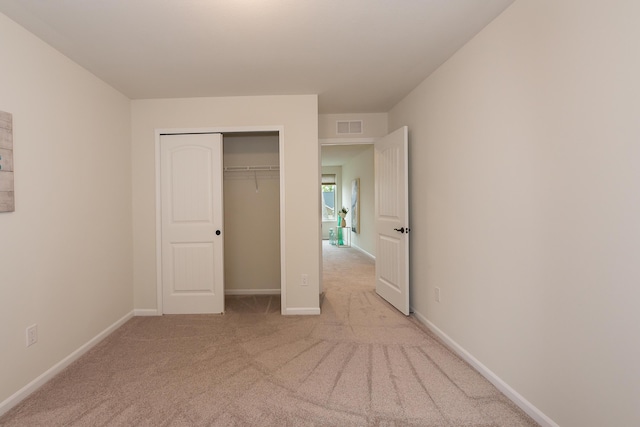 2767 St Regis Way, Ann Arbor, MI 48105 - unfurnished bedroom featuring light colored carpet, a closet, and baseboards