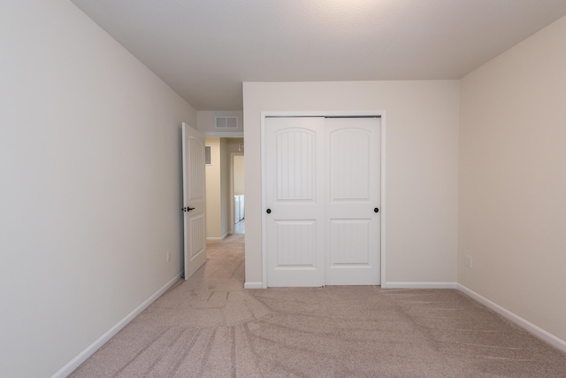 2767 St Regis Way, Ann Arbor, MI 48105 - unfurnished bedroom featuring light carpet, a closet, and baseboards