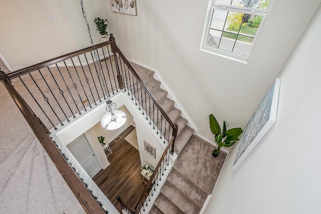 2767 St Regis Way, Ann Arbor, MI 48105 - stairway with baseboards, wood finished floors, and a high ceiling