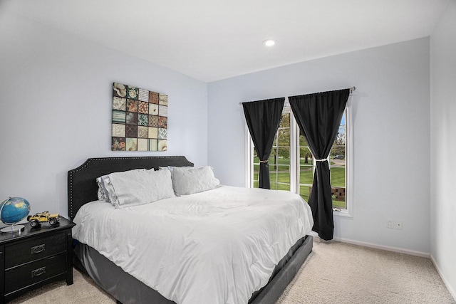 bedroom featuring light carpet, baseboards, and recessed lighting