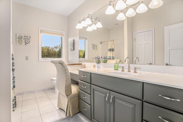 bathroom with tile patterned floors, toilet, baseboards, and vanity