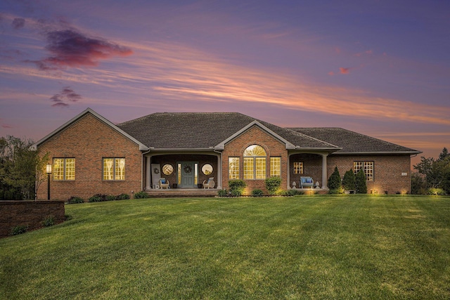 ranch-style house with brick siding and a front yard