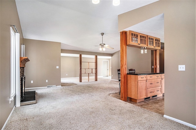 11630 Myers Lake Ave NE, Cedar Springs, MI 49319 - carpeted empty room featuring baseboards, a ceiling fan, and a brick fireplace