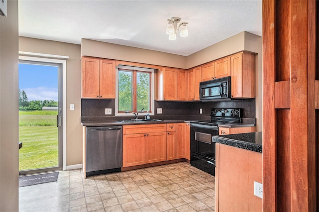 11630 Myers Lake Ave NE, Cedar Springs, MI 49319 - kitchen with black appliances, a sink, backsplash, and dark countertops