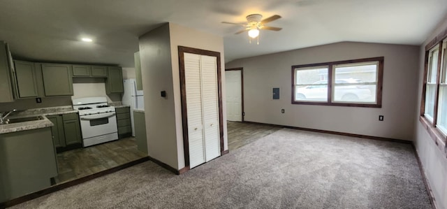 kitchen with white gas range oven, ceiling fan, carpet, light countertops, and vaulted ceiling