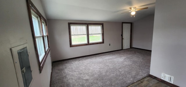 carpeted spare room with a ceiling fan and baseboards