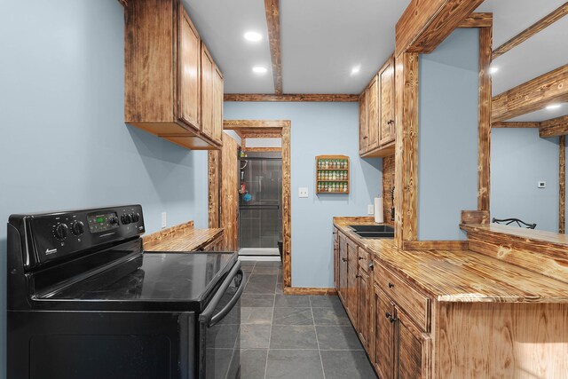 23748 Cutler Rd, Newaygo, MI 49337 - kitchen with black electric range, recessed lighting, brown cabinets, light countertops, and baseboards